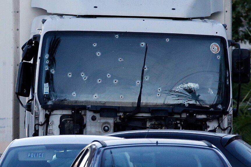 Bullet holes are seen on the heavy truck that ran into a crowd at high speed killing scores celebrating Bastille Day