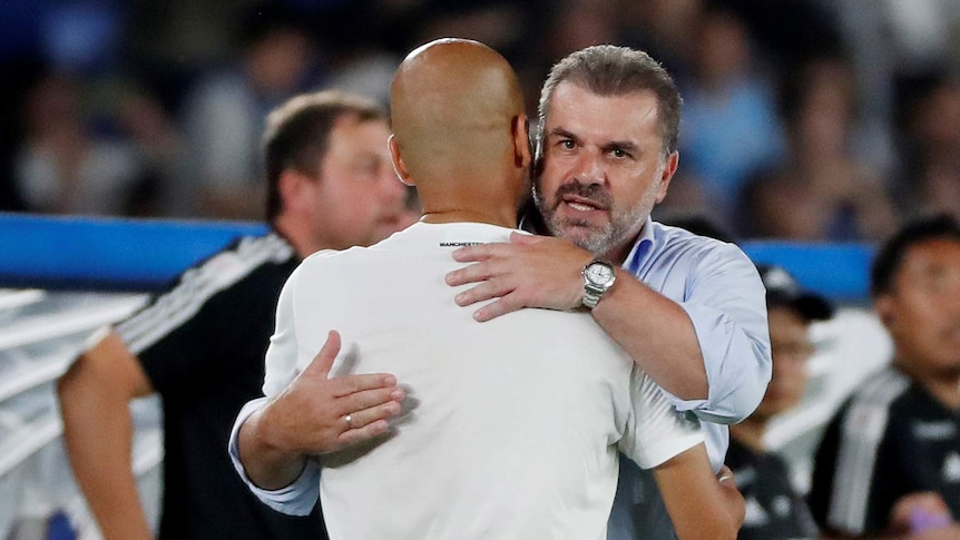 Ange Postecoglou hugs Pep Guardiola.