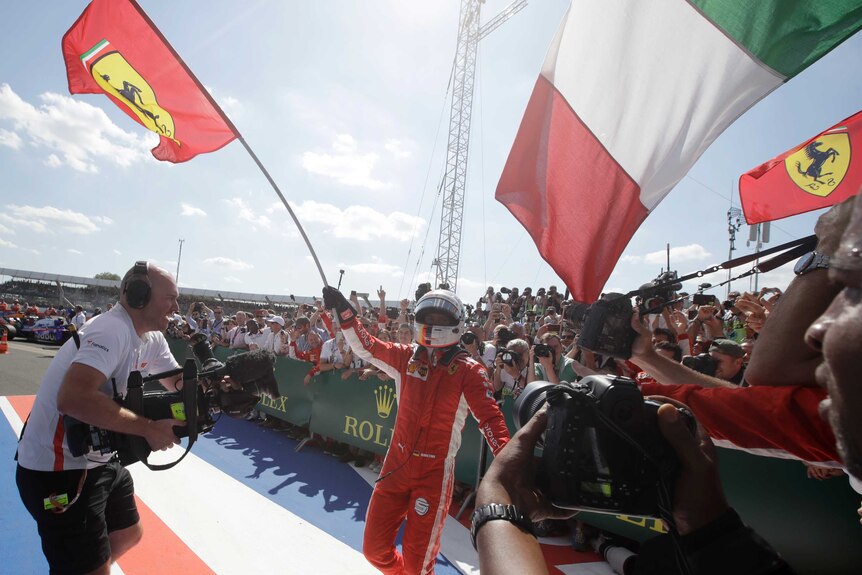 Ferrari driver Sebastian Vettel of Germany celebrates after winning the British F1 Grand Prix.