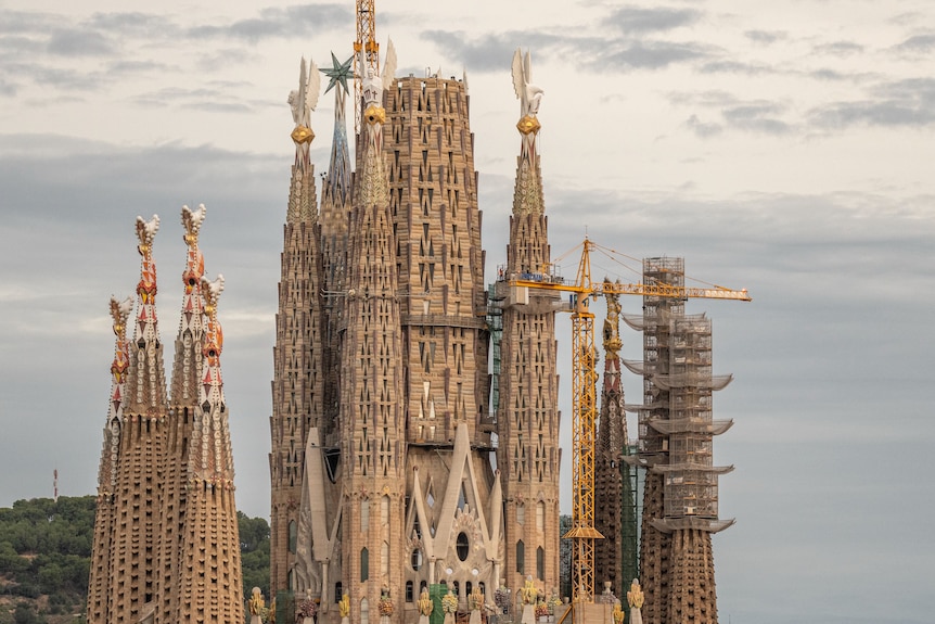 La Sagrada Familia in Barcelona with a crane near one of the towers