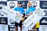 Rio Waida and Zoe Steyn with their winners cheques at the Ballito Pro in South Africa