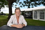 Former Redland Mayor Karen Williams sit at a table at a park.