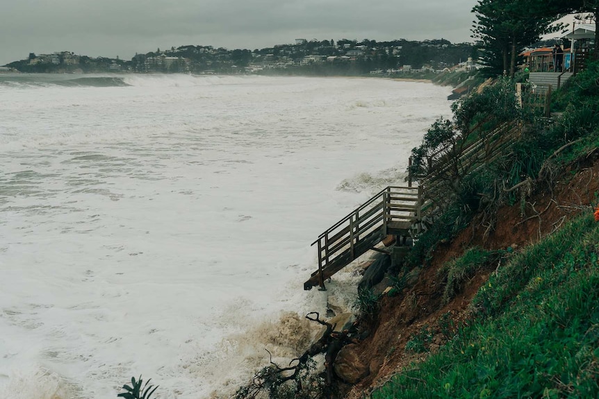 Wamberal beach disappears after at high tide as waves crash close to homes.