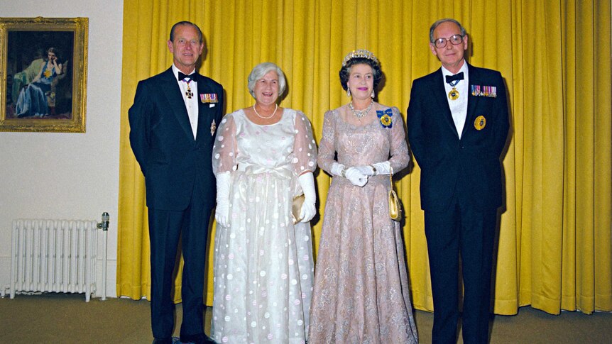 Queen Elizabeth II, the Duke of Edinburgh, Sir Ninian Stephen and Lady Stephen pose for a photo in formal wear
