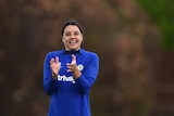 Sam Kerr claps her hands and smiles