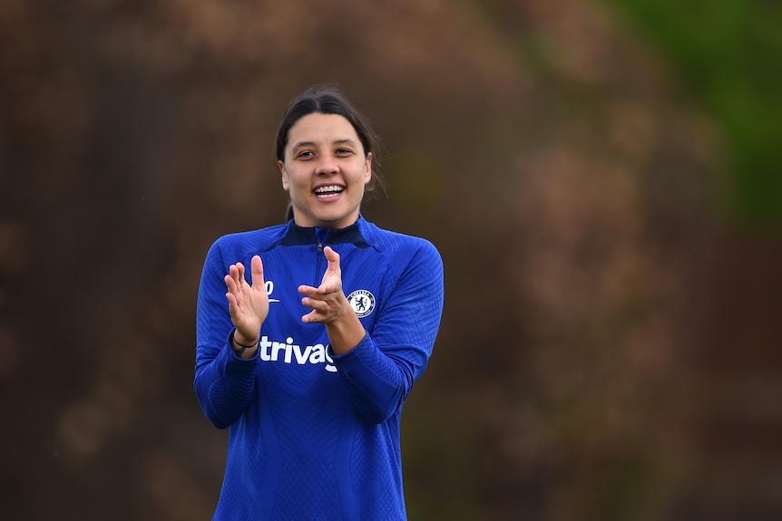 Sam Kerr claps her hands and smiles