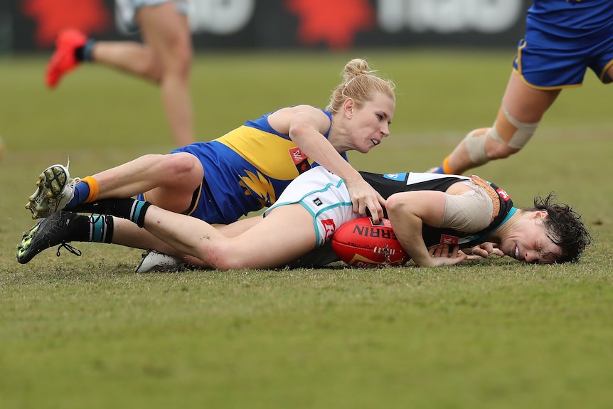 Ebony O'Dea lies on the ground after being tackled by Dana Hooker of the Eagles