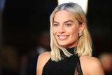 Margot Robbie poses for photos at the BAFTAs