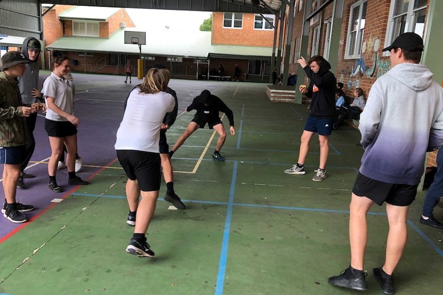 School students play handball in a playground