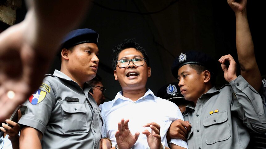 Reuters journalist Wa Lone is seen handcuffed as he departs court.