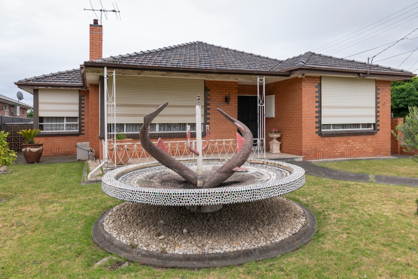 Garden feature in front of a suburban red brick house in Melbourne.