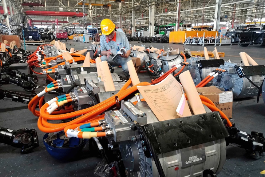 A man works in an auto parts factory in Liaocheng in eastern China