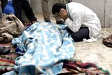Men mourn next to the body of a protester at a field hospital near Tahrir Square, Cairo.