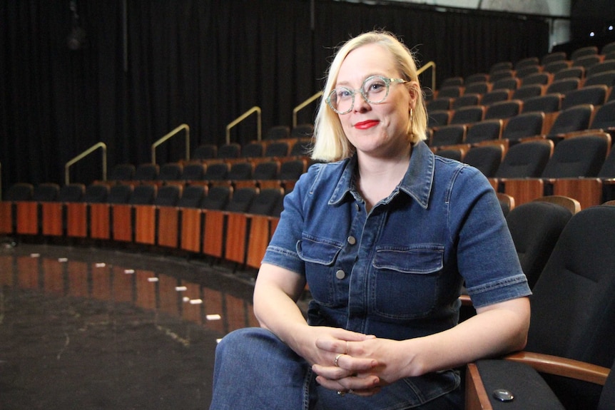 A woman in an empty theatre