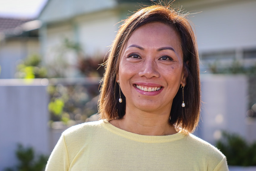 A woman with brown hair smiles