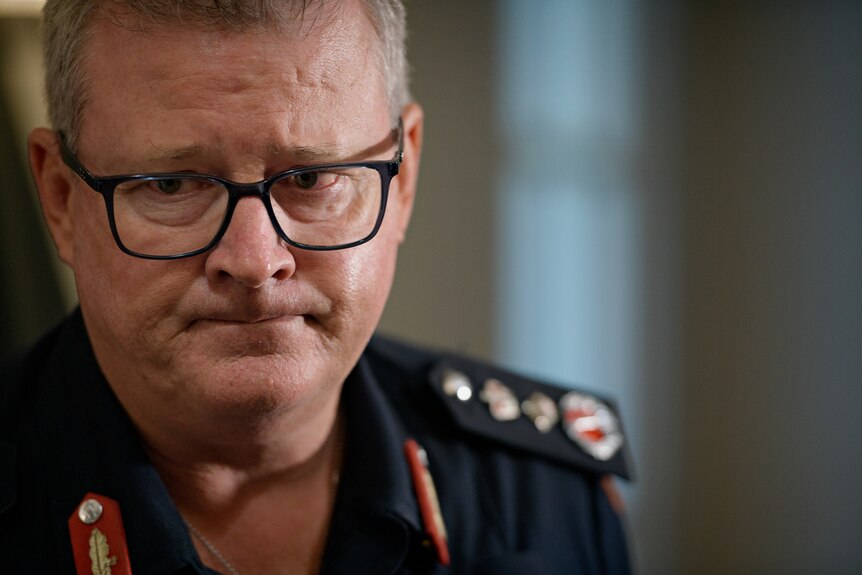NT Police Commissioner Jamie Chalker at a press conference, looking concerned.