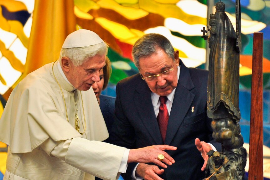 Pope Benedict XVI receives a statue of the Virgin of Charity of El Cobre as a present.