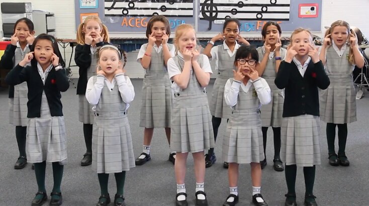A group of primary school students singing together.