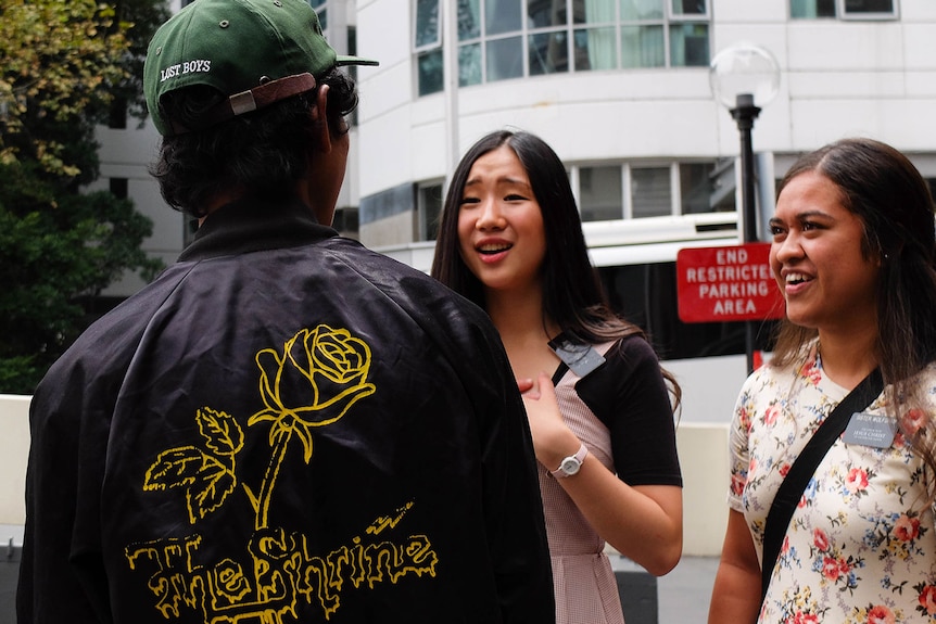 Missionaries Sister Lu and Sister Wolfgram talking to someone on the street