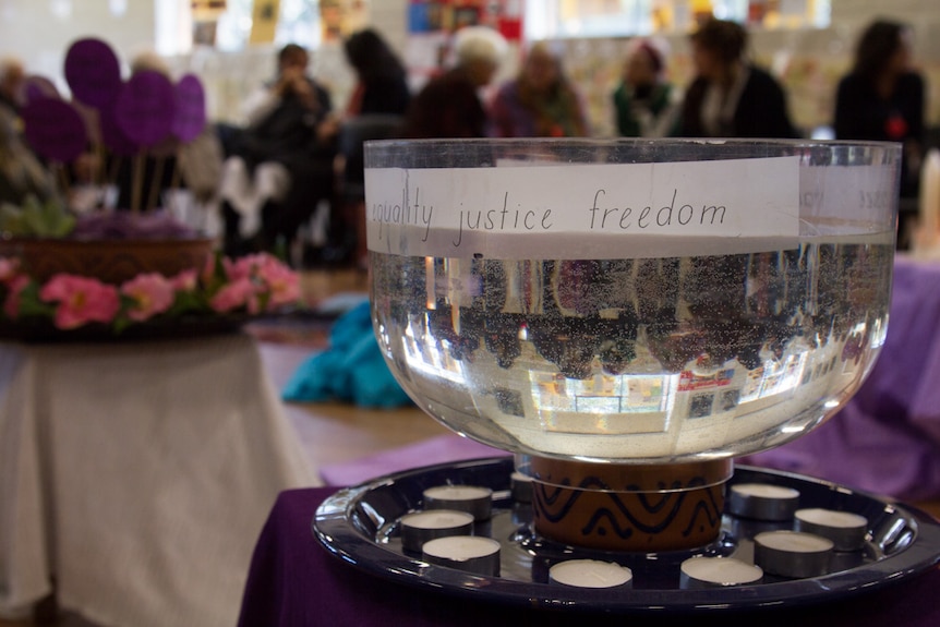 Words justice and freedom written on a bowl of water