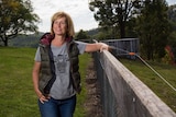 Debbie Pearce leans on a fence.