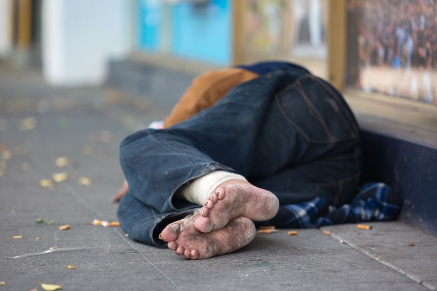 A homeless person sleeps on Fitzroy Street in St Kilda, November 19, 2018.