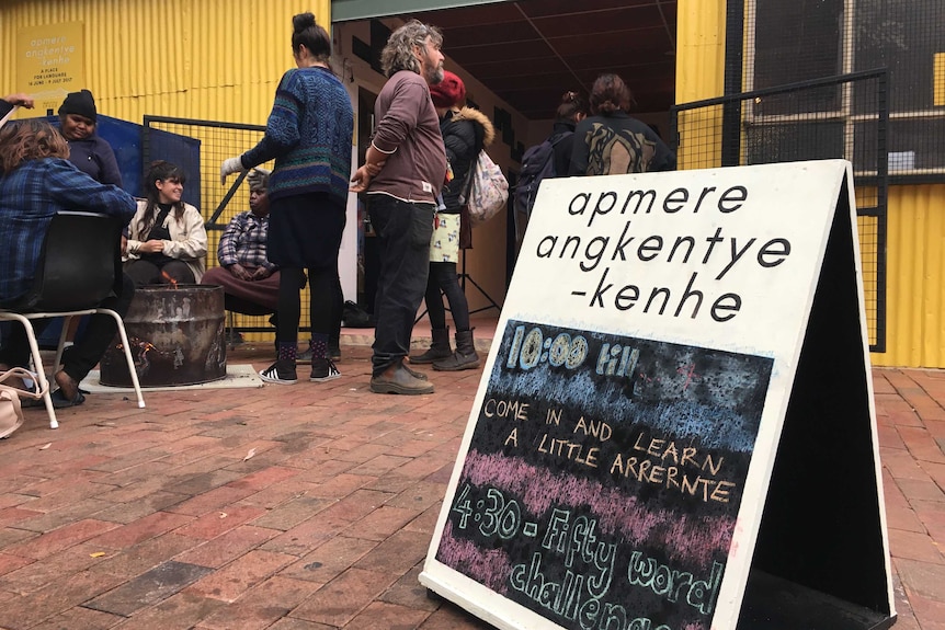 People mill around outside an Arrernte language classroom in Alice Springs.