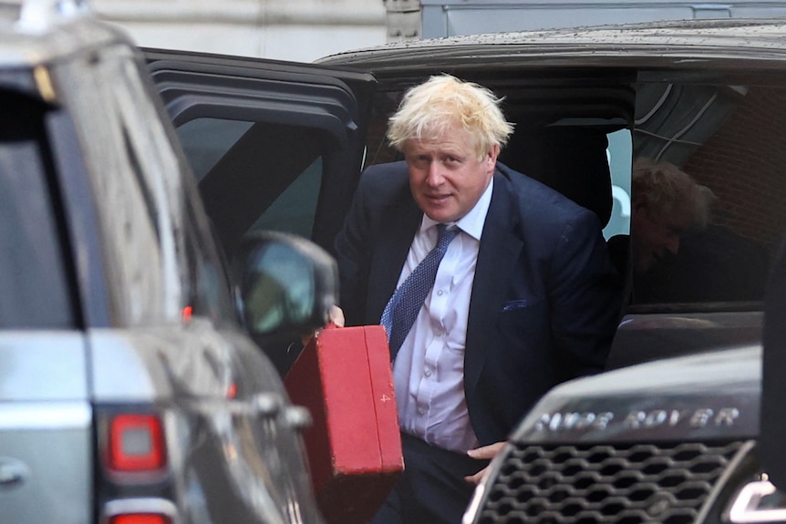 Boris Johnson arrives at Downing Street with a red briefcase.
