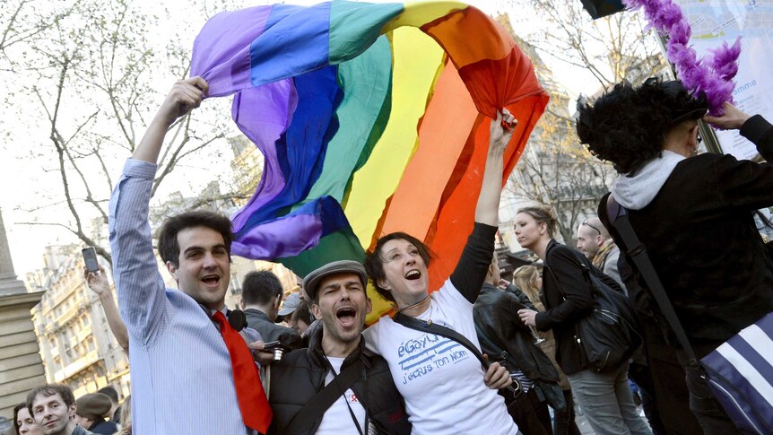 People celebrate after the French National Assembly adopted a bill legalising same-sex marriages.