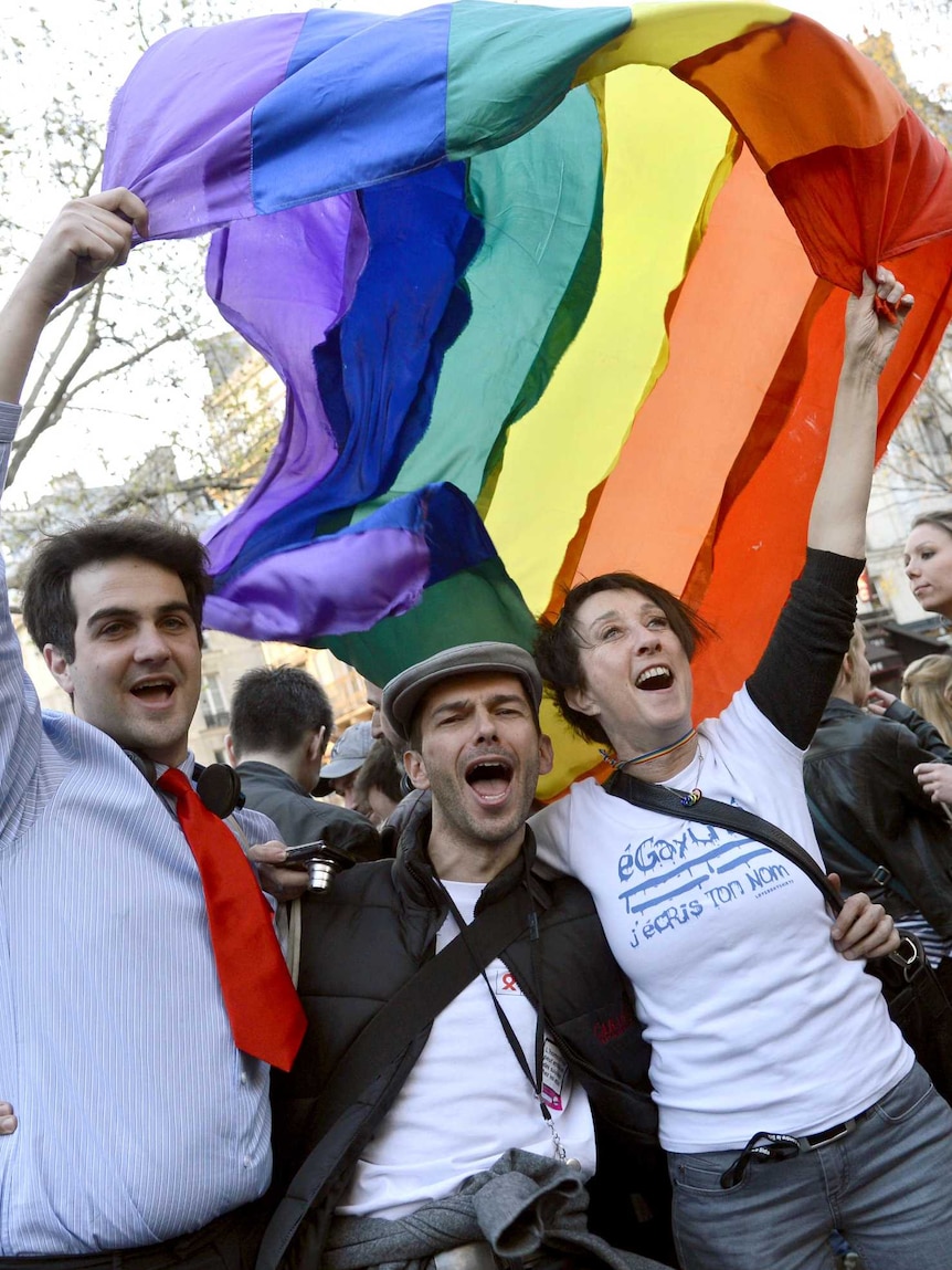 People celebrate after the French National Assembly adopted a bill legalising same-sex marriages.