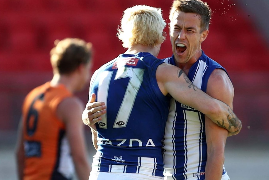 Trent Dumont screams in delight as Jasper Pittard gives him a hug