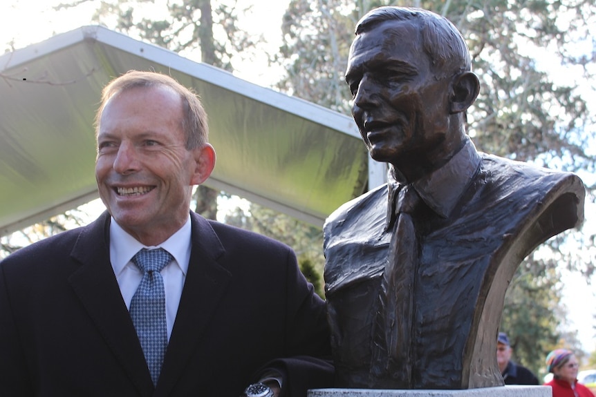 Former prime minister Tony Abbott stands in front of bronze bust of himself in Ballarat.