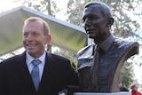Former prime minister Tony Abbott stands in front of bronze bust of himself in Ballarat.