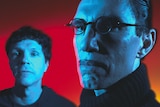 A blue-tinged Russell Mael and Ron Mael with a severe expression in front of a red background in The Sparks Brothers