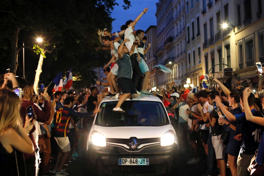 France fans dance on a car