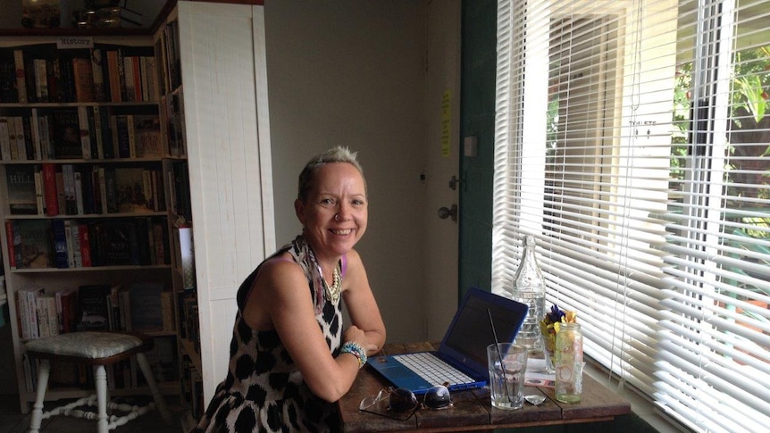 Author L.J Kidd at work in her tropical home writing a book