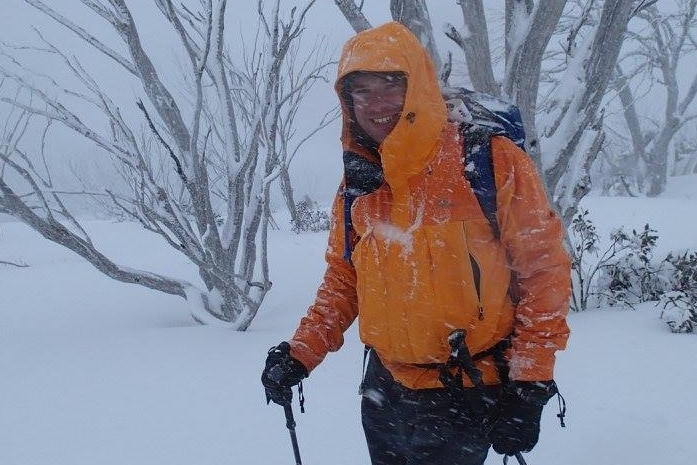 man in snow, smiling at camera