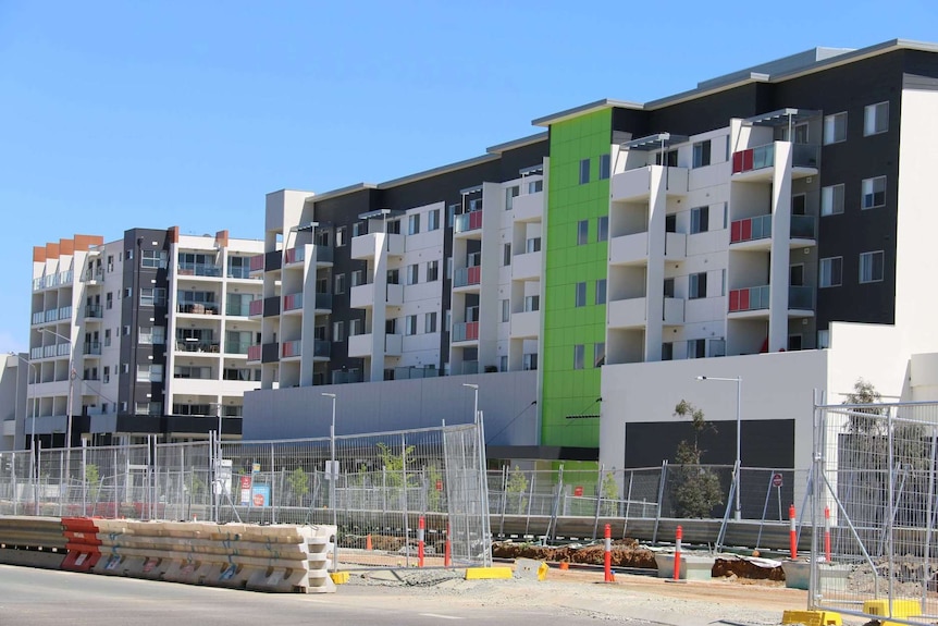 Colourful apartment blocks under construction.