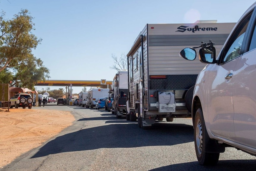 A line-up of caravans and tourists awaiting petrol.
