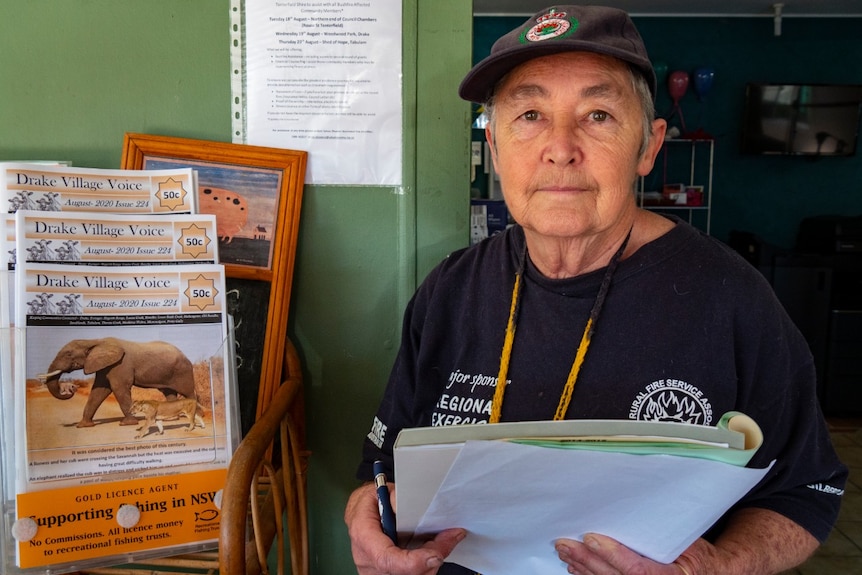 A woman wearing RFS gear holds a large notepad.