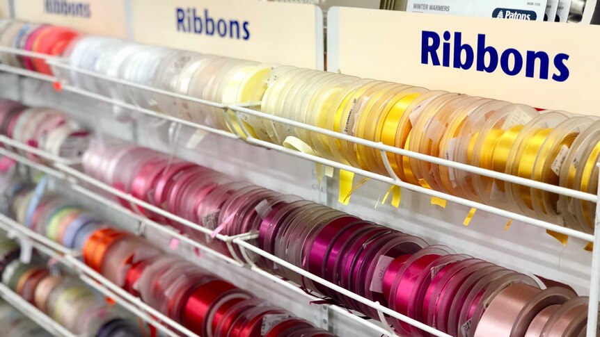 Colourful rolls of ribbons in a haberdashery shop.