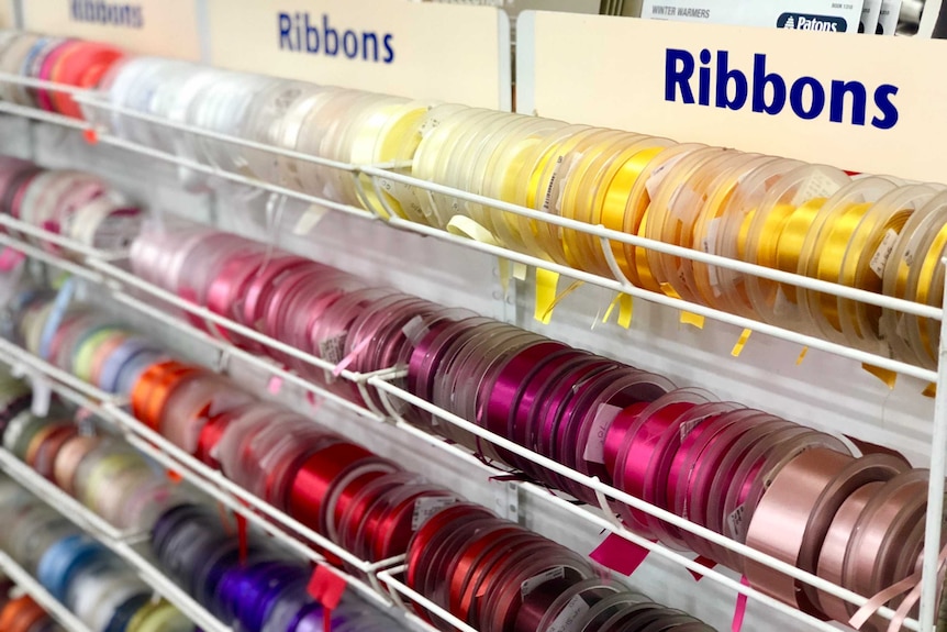 Colourful rolls of ribbons in a haberdashery shop.