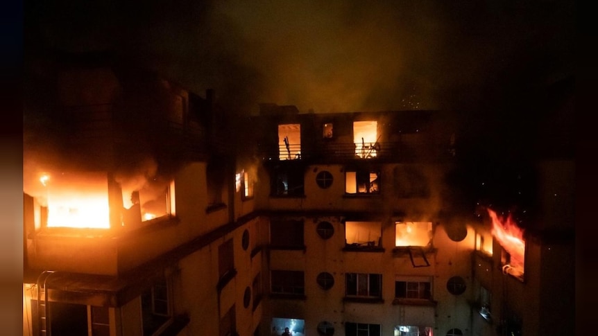A fire engulfs an apartment building in Paris.