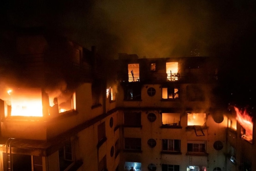 A fire engulfs an apartment building in Paris.