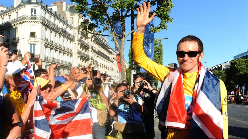 British cyclist Bradley Wiggins (R) celebrates with fans after winning the 2012 Tour de France.