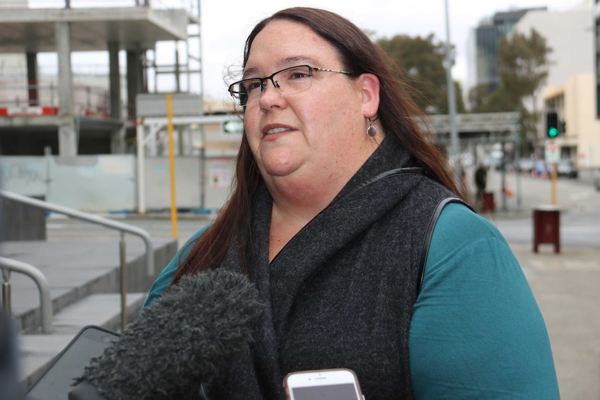 A mid-shot of Roy Arbon's lawyer Sarah Oliver speaking to media on the street outside a Perth court.