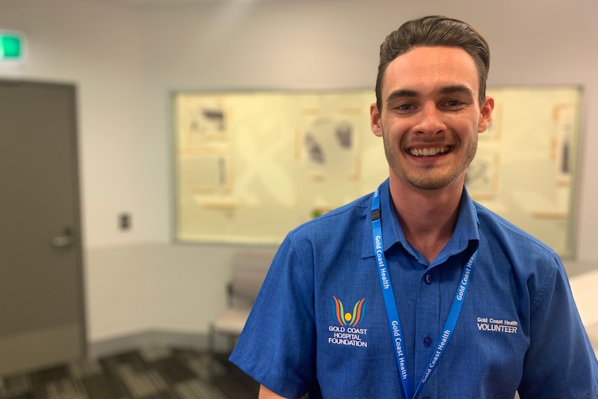 International pilot Blake Robinson who works as a volunteer, is standing at the Gold Coast University Hospital. 