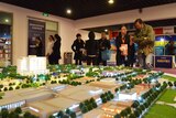 Chinese investors look at a display model of a Melbourne property development.