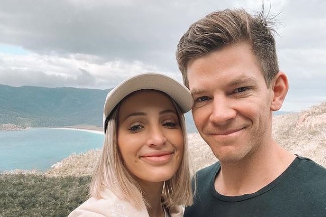 A woman and man taking a selfie at an outdoor lookout.