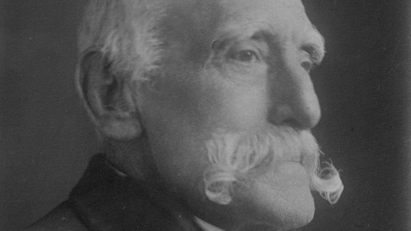 An 1800s photo of an old man with a large white moustache